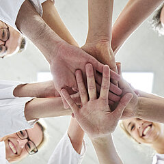 Reha-Klinik Personal legt motiviert die Hände aufeinander
